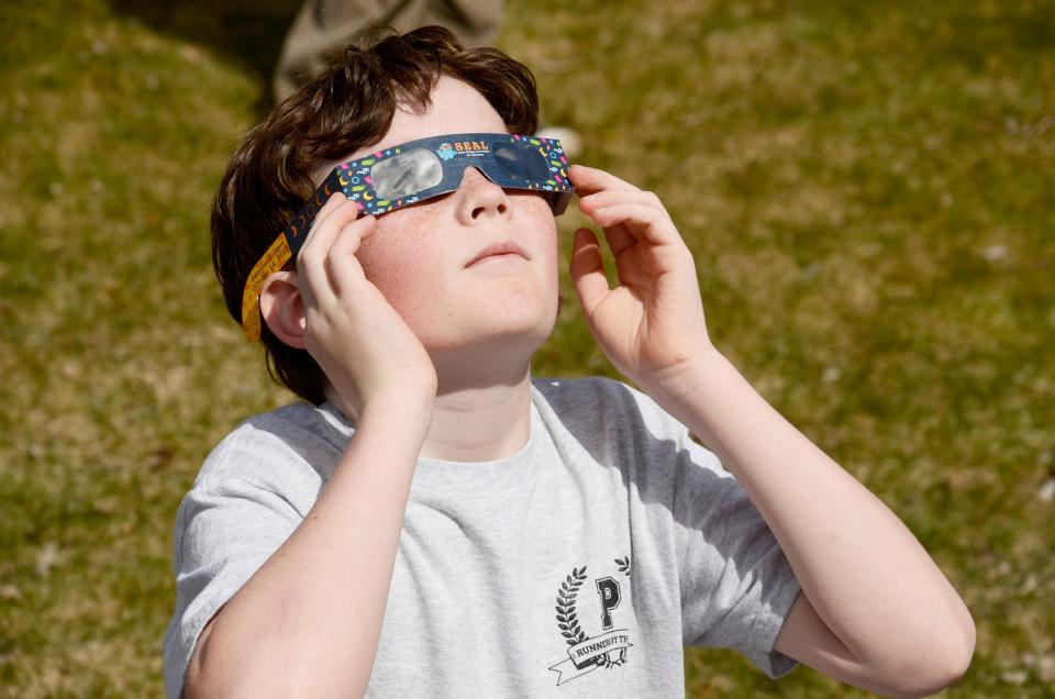 Finn Petersen, 11, of Petoskey watches the solar eclipse on Monday, April 8, 2024 at the Petoskey District Library.