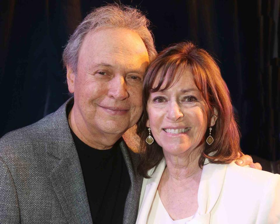 <p>Bruce Glikas/Getty</p> Billy Crystal and wife Janice Crystal posing backstage at the opening night of a musical based on the 1992 film 