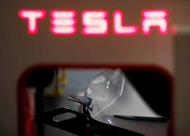 A Tesla car charges at a Supercharger station in Singapore