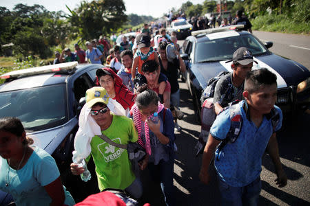 Central American migrants walk along the highway near the border with Guatemala, as they continue their journey trying to reach the U.S., in Tapachula, Mexico October 21, 2018. REUTERS/Ueslei Marcelino