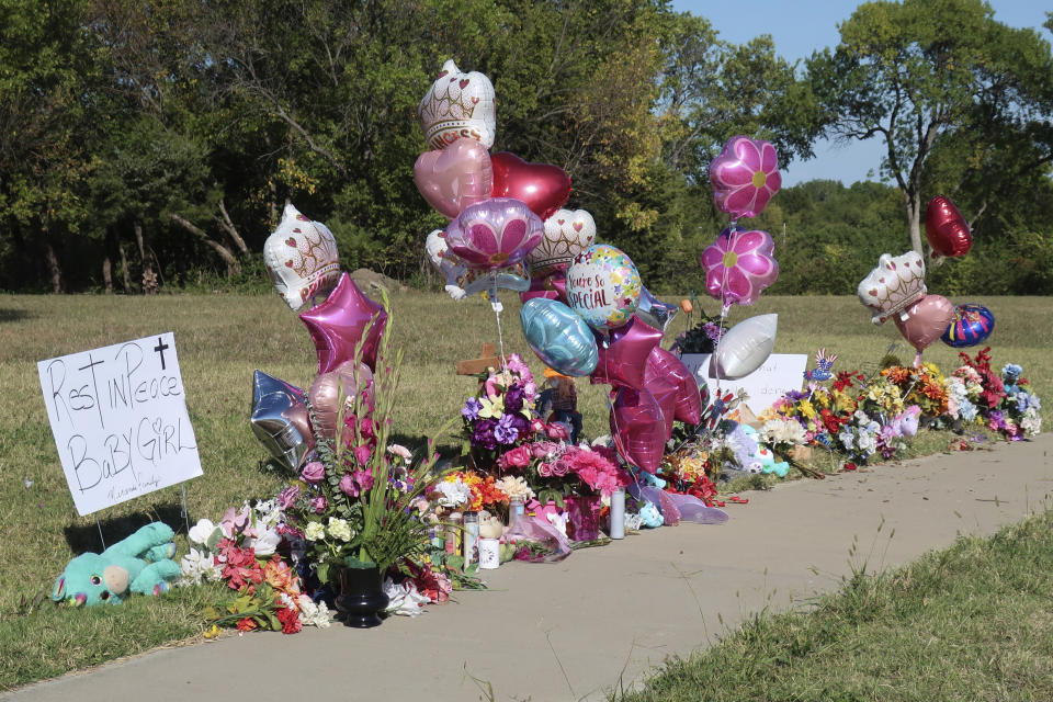 Zoey Felix, a 5-year-old girl, is honored with a makeshift memorial of flowers, balloons, signs and toys along a sidewalk, Thursday, Oct. 5, 2023, in Topeka, Kan. A homeless man was charged Thursday with murder and rape in the killing of Felix. (AP Photo/John Hanna)