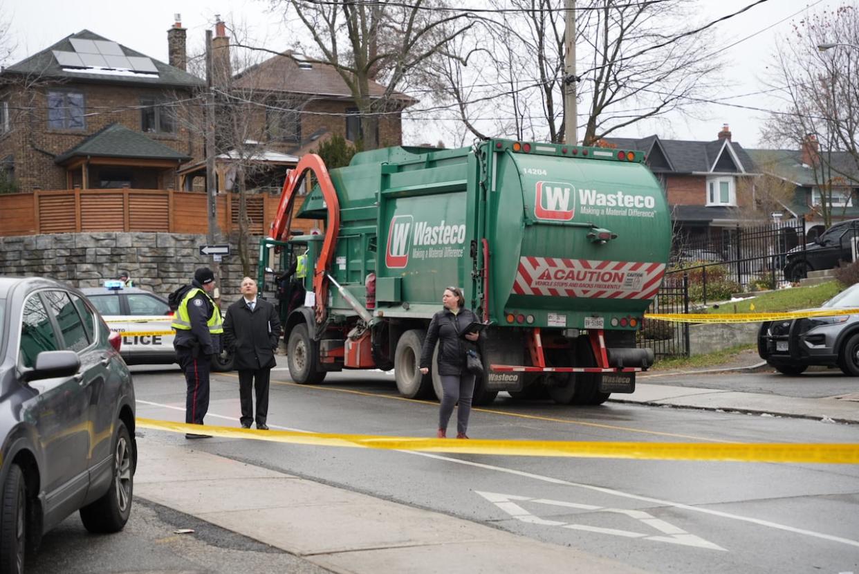 A woman died after being struck by a garbage truck in midtown Toronto Thursday, police say. (Prasanjeet Choudhury/CBC - image credit)