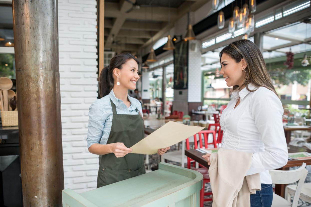 Woman speaking to hostess