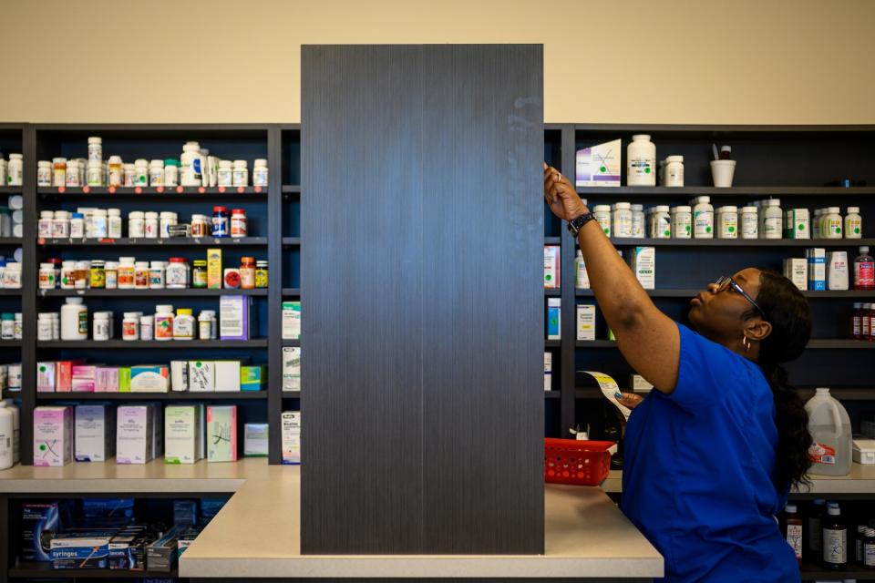 Pharmacy technician Precious Parker fills patient prescriptions.