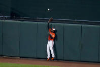 Baltimore Orioles center fielder Cedric Mullins goes up to make a warning track catch on a ball hit by Boston Red Sox's Enrique Hernandez during the fifth inning of a baseball game, Saturday, April 10, 2021, in Baltimore. (AP Photo/Julio Cortez)