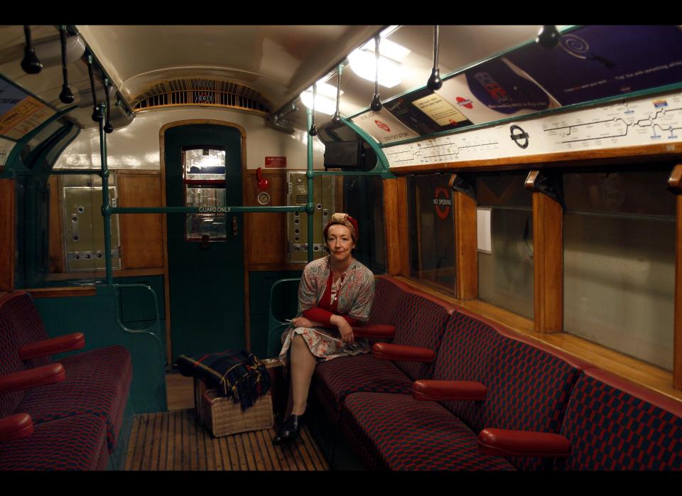 An actor dressed in sits in a 1938 tube train at Aldwych Underground station in London, Thursday, Sept. 23, 2010.     AP Photo/Kirsty Wigglesworth