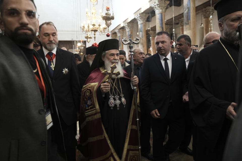 Greek Orthodox Patriarch of Jerusalem Teophilos III walks in the Nativity Church, where Christians believe Jesus Christ was born on the eve of the Orthodox Christmas in Bethlehem, West Bank, Saturday, Jan. 6, 2024. (AP Photo/Mahmoud Illean)