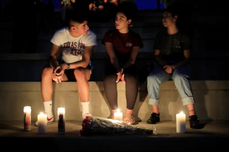 Mourners take part in a vigil at El Paso High School after a mass shooting at a Walmart store in El Paso