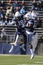 Connecticut defensive back Durante Jones (19) and defensive lineman Kevon Jones (48) celebrate a defensive stop during the first half of an NCAA football game against Houston, Saturday, Nov. 27, 2021, in East Hartford, Conn. (AP Photo/Stew Milne)