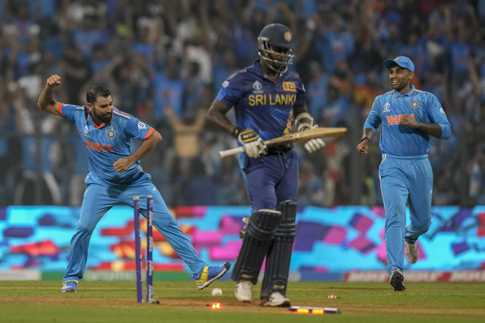 India's Mohammed Shami, left, celebrates the dismissal of Sri Lanka's Angelo Mathews, center, during the ICC Men's Cricket World Cup match between India and Sri Lanka in Mumbai, India, Thursday, Nov. 2, 2023. (AP Photo/Rafiq Maqbool)