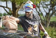 Carolina Panthers defensive end Brian Burns has a hat for all occasions as he unpacks his car at the team's dormitory at NFL football training camp, Tuesday, July 27, 2021, at Wofford College in Spartanburg, S.C. (Jeff Siner/The Charlotte Observer via AP)