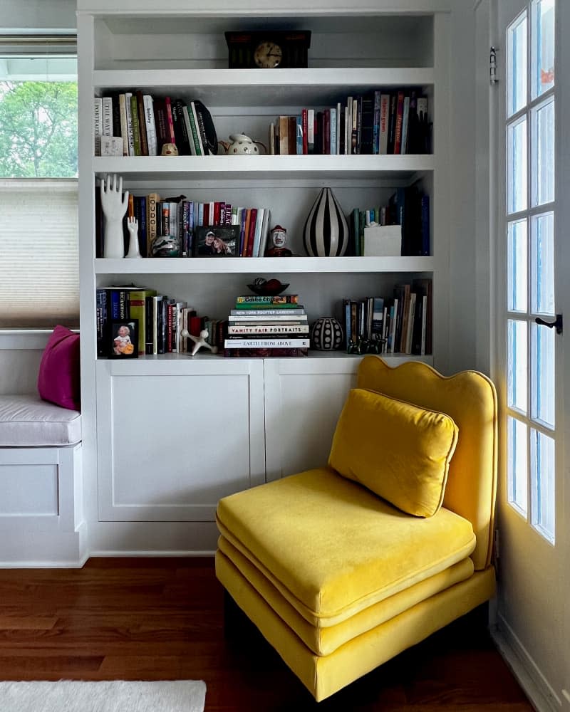 Yellow armchair in corner of newly renovated living room.