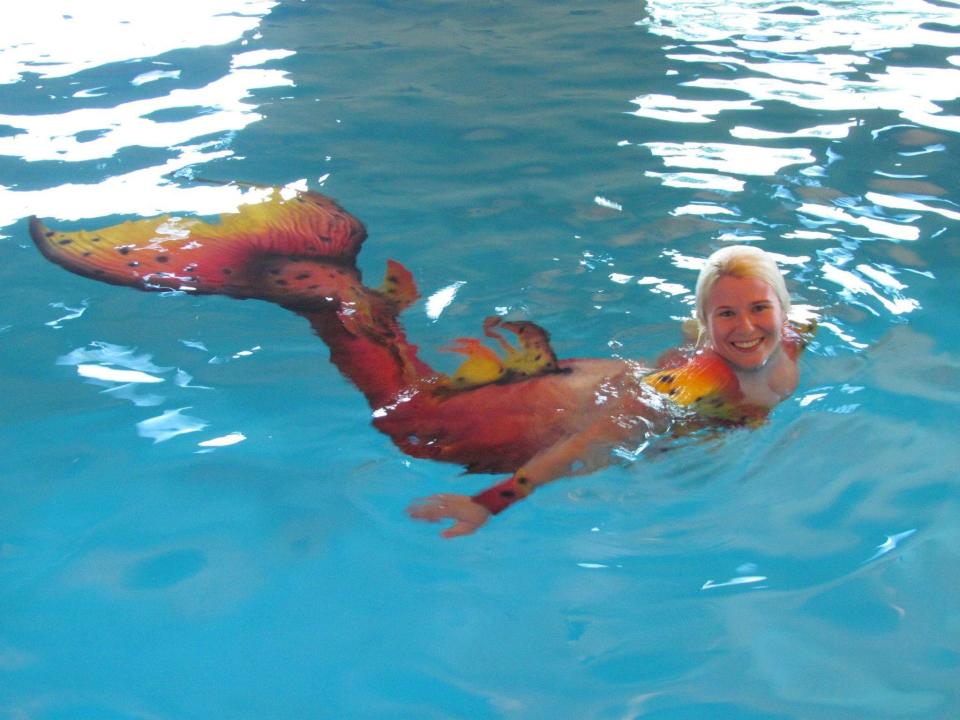 Olivia Hammock poses for a portrait in a mermaid tail. While a student at Missouri State University, she swam in the Foster Recreation Center pool with her tail, becoming popularly known as the "Missouri State Mermaid."