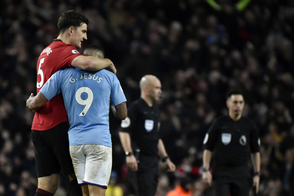 Manchester United's Harry Maguire, left, and Manchester City's Gabriel Jesus react at the end of the English Premier League soccer match between Manchester City and Manchester United at Etihad stadium in Manchester, England, Saturday, Dec. 7, 2019. (AP Photo/Rui Vieira)