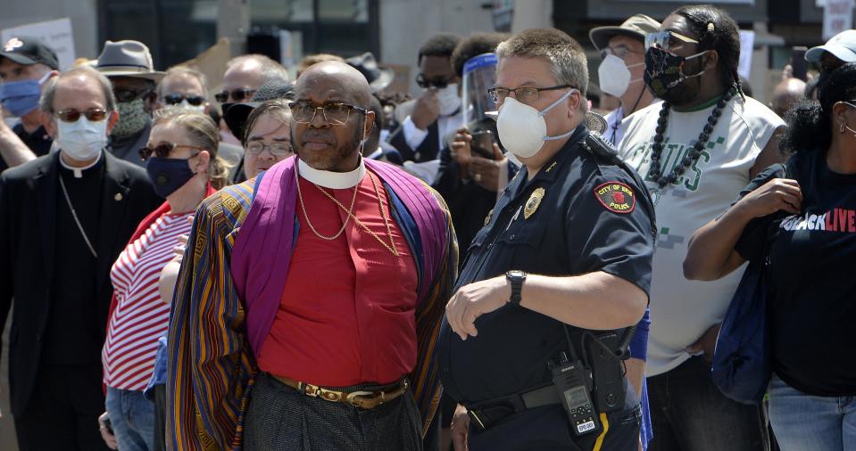 Bishop Dwane Brock, center left, and Erie Chief of Police Dan Spizarny talk before a silent march on State Street on June 6, 2020. Brock organized the march as an estimated 2,500 people walked from 11th and State streets to Perry Square to protest the killing of George Floyd on Memorial Day 2020 in Minneapolis.