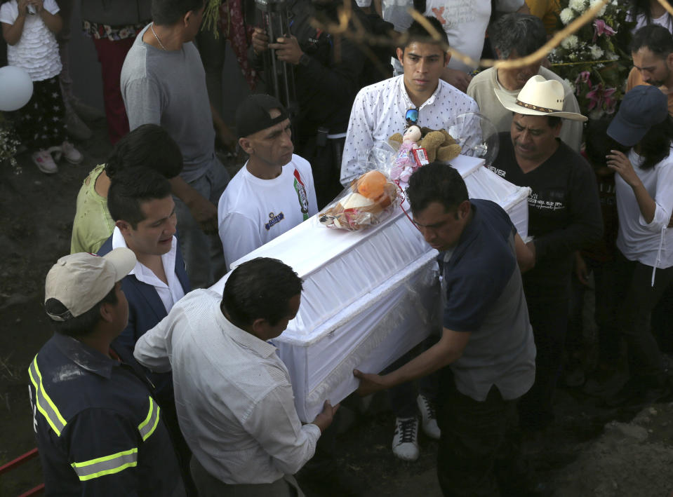 Family members bury 7-year-old murder victim Fatima in Mexico City, Tuesday, Feb. 18, 2020. Fatima's body was found wrapped in a bag and abandoned in a rural area on Saturday. Five people have been questioned in the case, and video footage of her abduction exists. (AP Photo/Marco Ugarte)