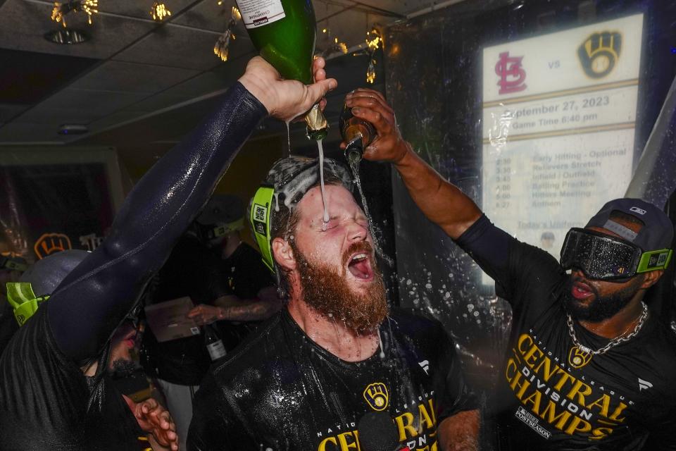 Milwaukee Brewers' Brandon Woodruff is douced as they celebrate after clinching the National League Central Division after a baseball game against the St. Louis Cardinals Tuesday, Sept. 26, 2023, in Milwaukee. (AP Photo/Morry Gash)