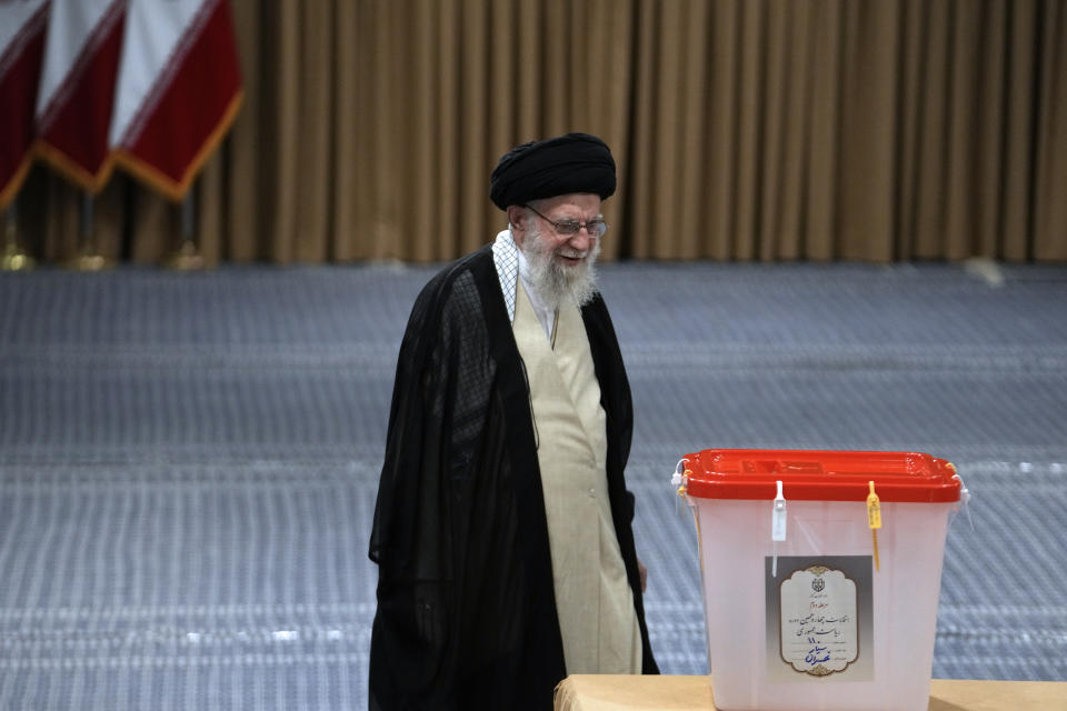 Iranian Supreme Leader Ayatollah Ali Khamenei walks towards the ballot box to vote for the presidential runoff election in Tehran, Iran, Friday, July 5, 2024. Iranians are voting in a runoff election to replace the late President Ebrahim Raisi, who was killed in a May helicopter crash in the country’s northwest along with the foreign minister and several other officials. (AP Photo/Vahid Salemi)