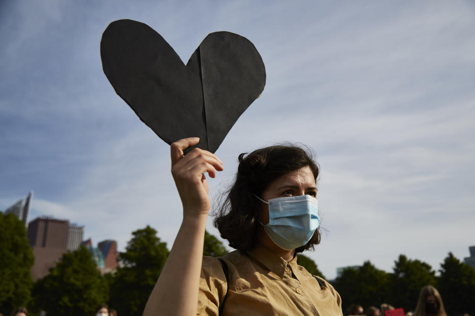 THE HAGUE, NETHERLANDS - JUNE 02: A protester holds a sign in protest as people gather on Malieveld in The Hague to attend a solidarity rally against racism in the aftermath of the killing of George Floyd by U.S. police officers on June 2, 2020 in The Hague, Netherlands. The rally is organized by KOZP (Kick Out Zwarte Piet), anti-racist activists against the Dutch Christmas tradition when people paint their face black and disguise in slave. (Photo by Pierre Crom/Getty Images)