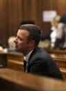 Olympic and Paralympic track star Oscar Pistorius reacts in the dock during his trial for the murder of his girlfriend Reeva Steenkamp, at the North Gauteng High Court in Pretoria, March 10, 2014. Pistorius is on trial for murdering Steenkamp at his suburban Pretoria home on Valentine's Day last year. He says he mistook her for an intruder. REUTERS/Siphiwe Sibeko (SOUTH AFRICA - Tags: CRIME LAW SPORT ATHLETICS)