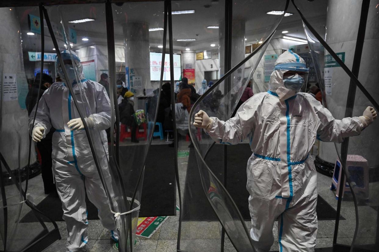 Medical staff members wearing protective clothing at a hospital in Wuhan, the coronavirus epicentre: AFP via Getty Images