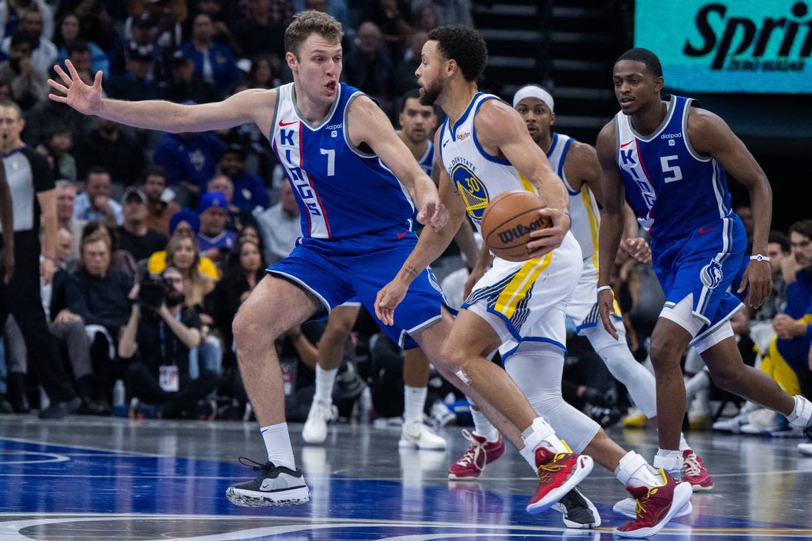 Sacramento Kings forward Sasha Vezenkov (7) defends Golden State Warriors guard Stephen Curry (30) during an NBA in-season tournament game at Golden 1 Center in November.