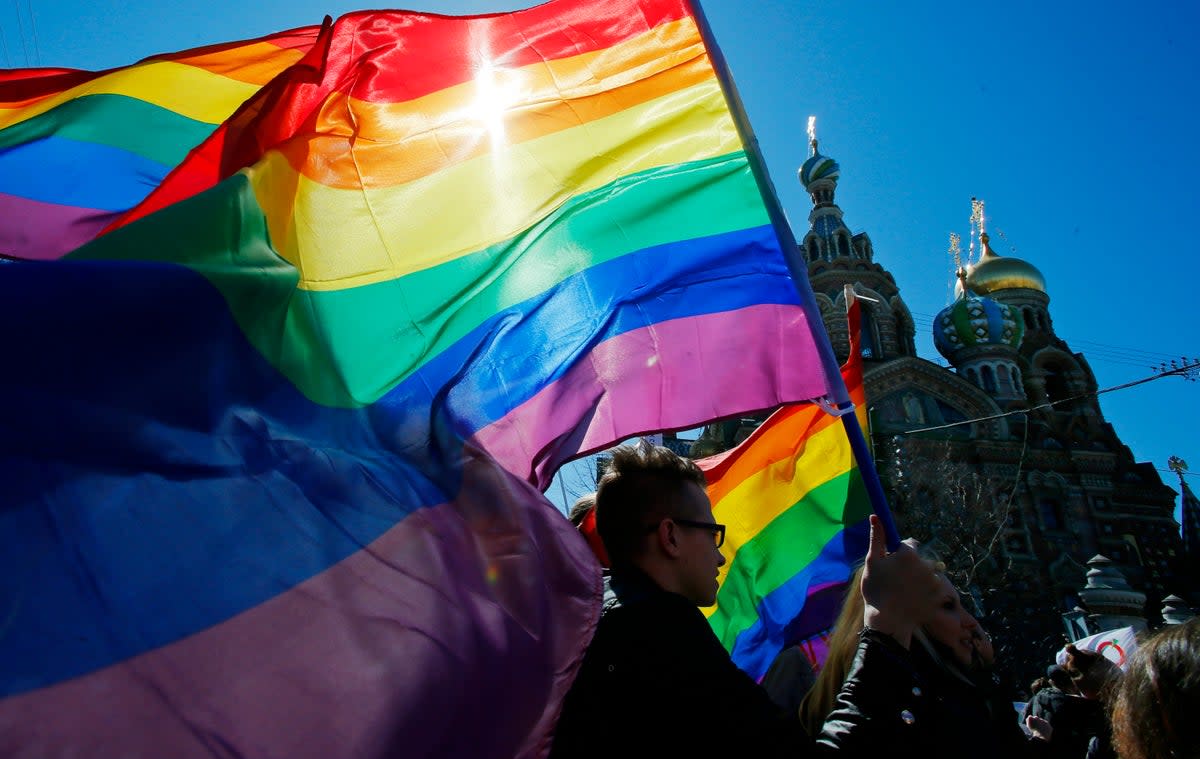 Gay rights activists carry rainbow flags as they march during a May Day rally in St. Petersburg, Russia (File photo).  (Copyright 2013 The Associated Press. All rights reserved)