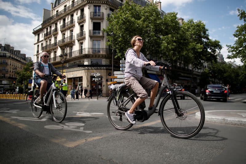 FILE PHOTO: A woman rides an electric bike as the country eases lockdown measures taken to curb the spread of the coronavirus disease (COVID-19) in Paris