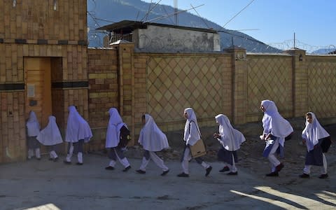 Students arrive at the Khpal Kor Model School, which was built with Malala Yousafzai's Nobel prize money - Credit:  AFP/ABDUL MAJEED