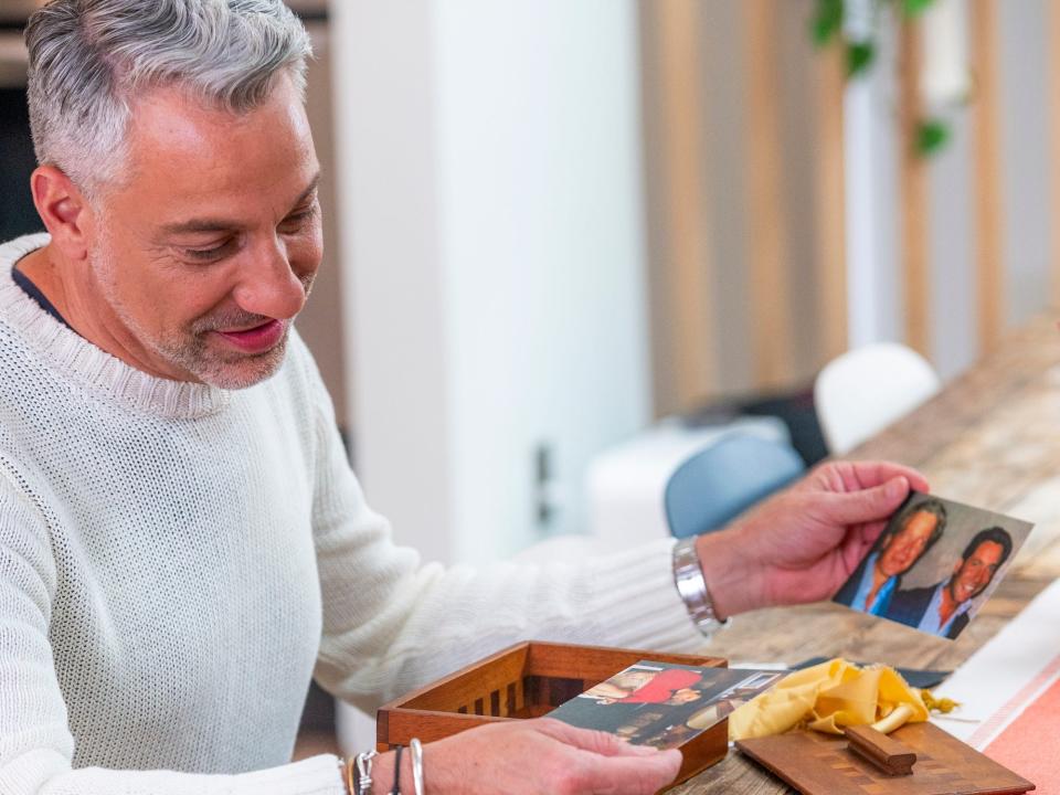 Thom Filicia looking at photos of his brother