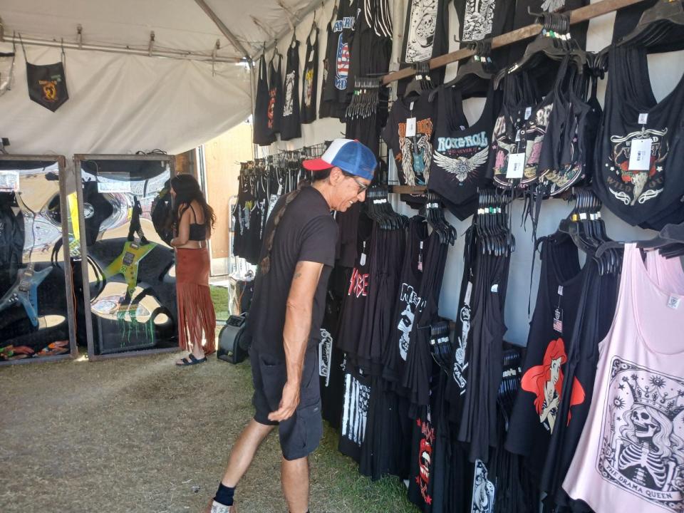 A customer checks out the merch at Dimebag Hardware at Welcome To Rockville Day 3.