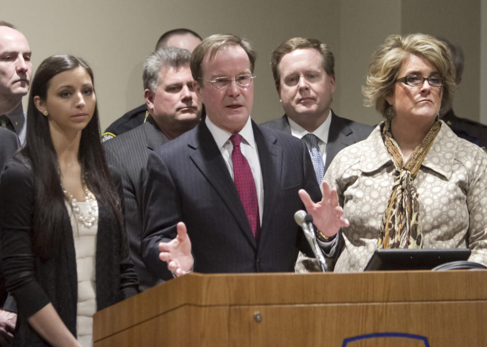 Michigan Attorney general Bill Schuette speaks at a news conference after the sentencing of Raulie Casteel, Monday, March 3, 2014 in Howell, Mich. On the left is victim Jennifer Kupiec, and at right is victim Loriann Arthur. Casteel, who kept a swath of southeastern Michigan on edge for weeks by shooting at two-dozen vehicles along a busy highway corridor, was sentenced to 18 to 40 years in prison on a combination of terrorism and weapons convictions. (AP Photo/Livingston County Daily Press & Argus, Gillis Benedict, Pool Photo)