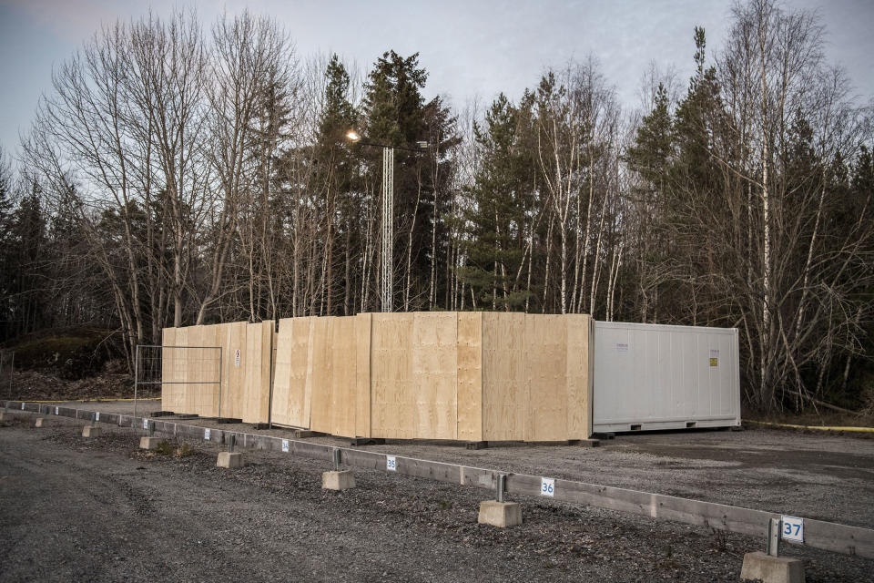 Refrigeration containers to be used on standby as makeshift morgues to store people who have died from COVID-19 set up behind Karolinska University Hospital in Huddinge, Sweden on March 26, 2020.<span class="copyright">IBL/Shutterstock</span>