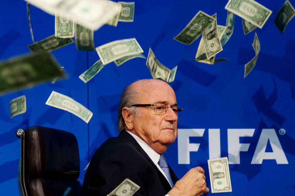 Sepp Blatter was showered in dollar bills during a news conference. (Getty)