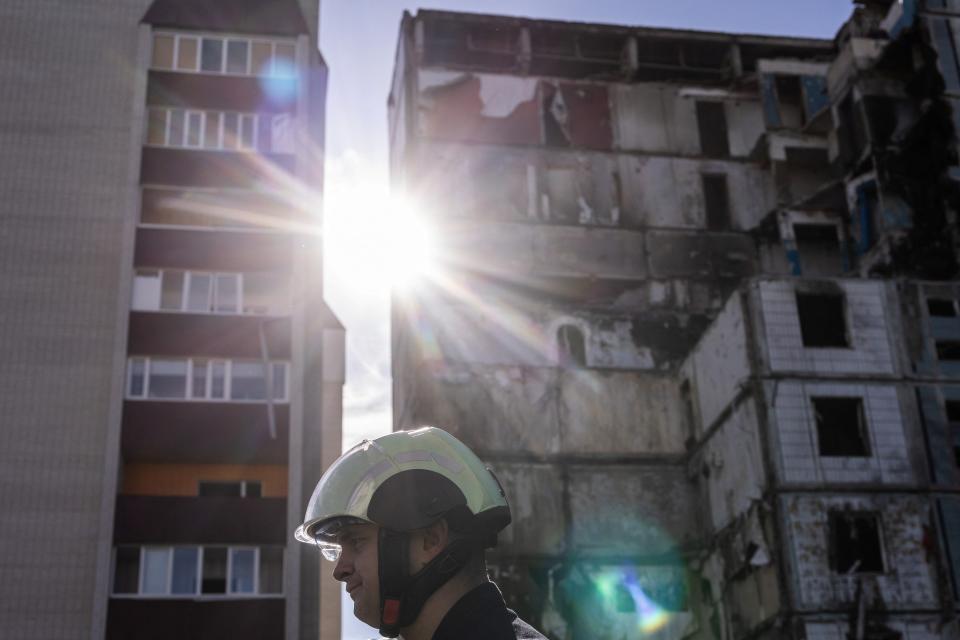 Rescuers are seen at a building destroyed by yesterday's Russian missile strike in the town of Uman (REUTERS)