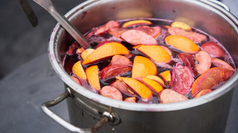 Large pot of mulled wine with fruit