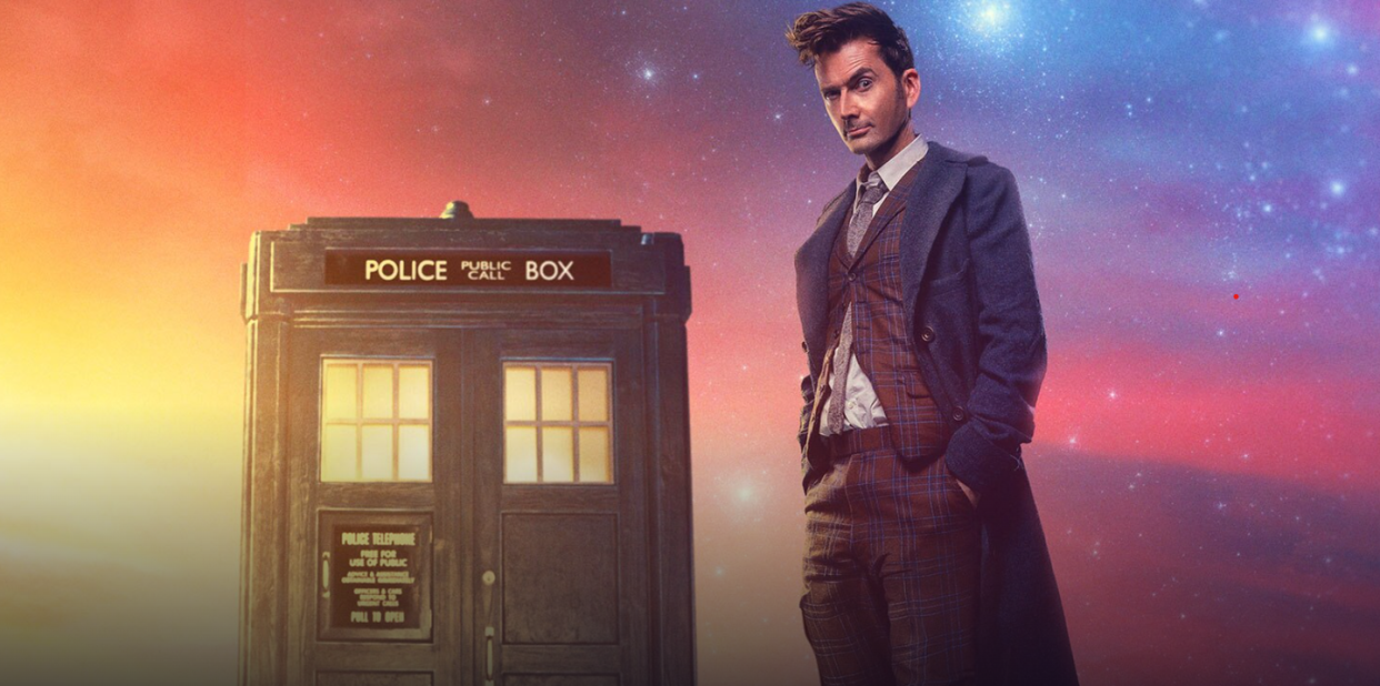 david tennant as the fourteenth doctor in doctor who, standing in front of the tardis with a brightly coloured backdrop