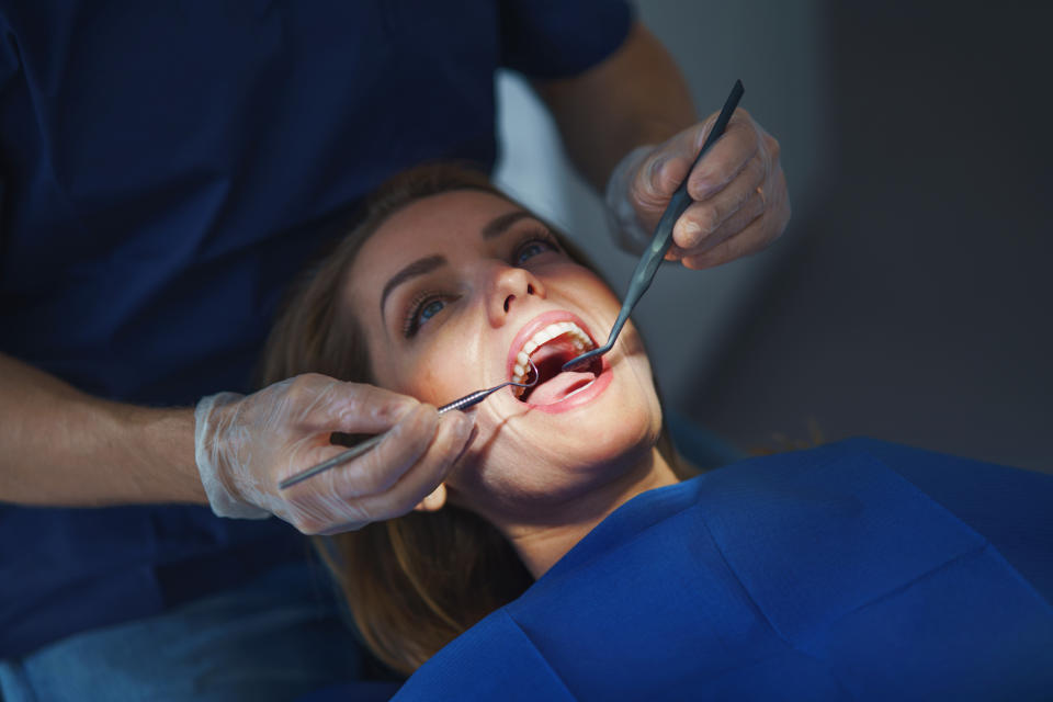 A woman is at the dentist