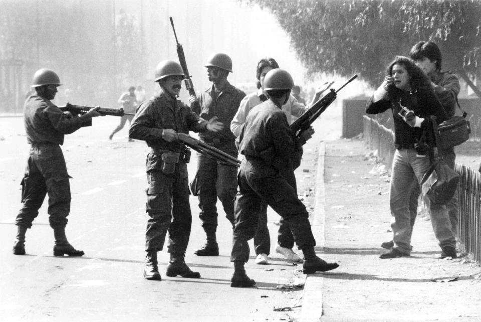 Army soldiers detain journalists during a peace demonstration along the Alameda avenue in downtown Santiago, Chile, May 20, 1986. (AP Photo/Marco Ugarte)