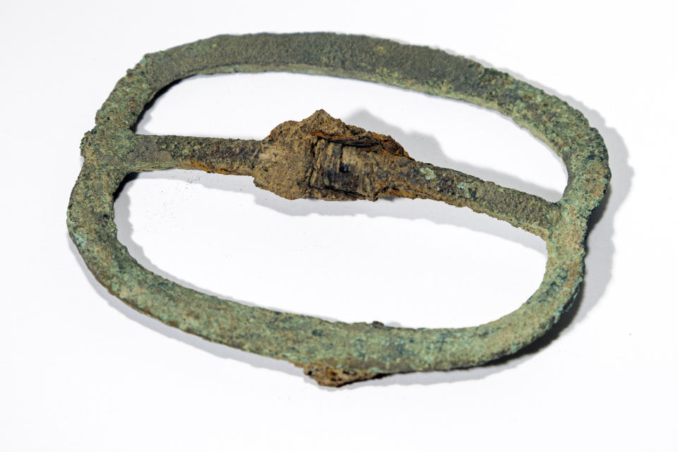 This image provided by Colonial Williamsburg Foundation, shows military buckle was excavated in the summer of 2023 by archaeologists at Colonial Williamsburg, a living history museum in Virginia. The buckle was found at the site of what was believed to be a military barracks during the American Revolution. The museum announced the site’s discovery on Tuesday, May 14, 2024. (Brendan Sostak/Colonial Williamsburg Foundation via AP)