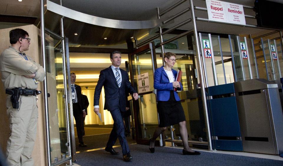 NATO Secretary General Anders Fogh Rasmussen, center, walks out of a hallway of NATO headquarters as he prepares to deliver a statement on Ukraine in Brussels on Sunday, March 2, 2014. NATO is calling emergency talks on Sunday regarding the escalating crisis in Ukraine. (AP Photo/Virginia Mayo)