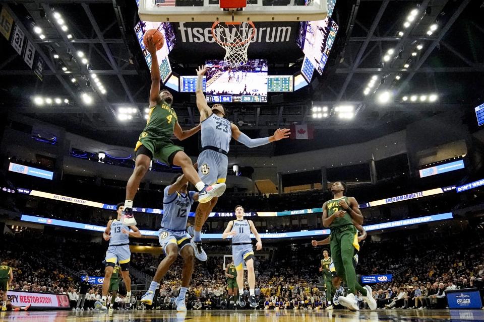 Marquette's David Joplin blocks a shot by Baylor's LJ Cryer during the second half of an NCAA college basketball game Tuesday, Nov. 29, 2022, in Milwaukee. (AP Photo/Morry Gash)
