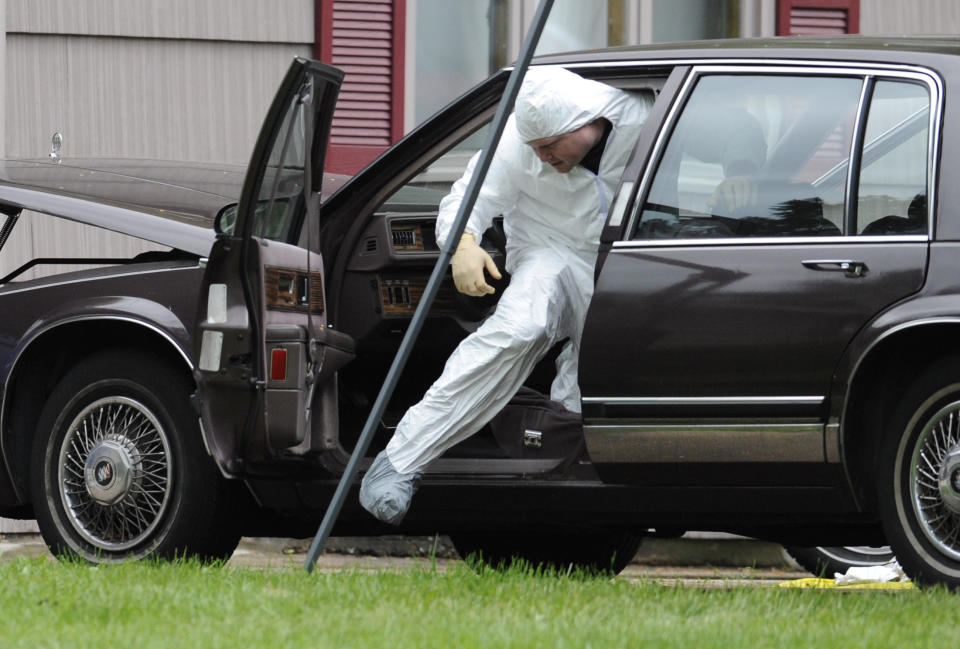 A Law enforcement agent searches a vehicle at the home of reputed Connecticut mobster Robert Gentile in Manchester, Conn., Thursday, May 10, 2012. Gentile's lawyer A. Ryan McGuigan says the FBI warrant allows the use of ground-penetrating radar and believes they are looking for paintings stolen from Boston's Isabella Stewart Gardener Museum worth half a billion dollars. (AP Photo/Jessica Hill)