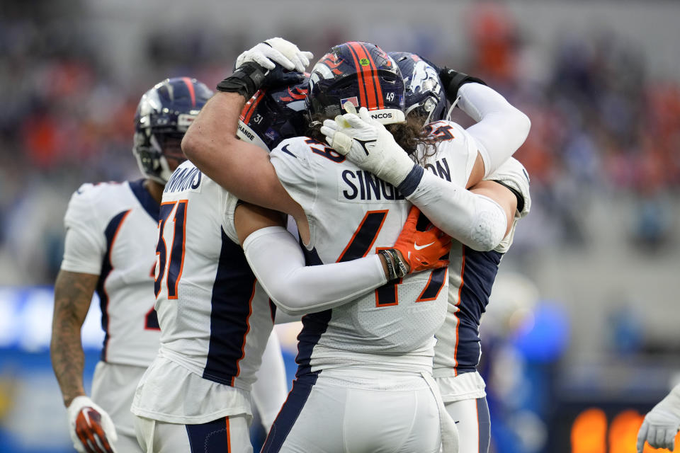 Denver Broncos players celebrate a sack by Zach Allen during the first half of an NFL football game against the Los Angeles Chargers Sunday, Dec. 10, 2023, in Inglewood, Calif. (AP Photo/Marcio Jose Sanchez)