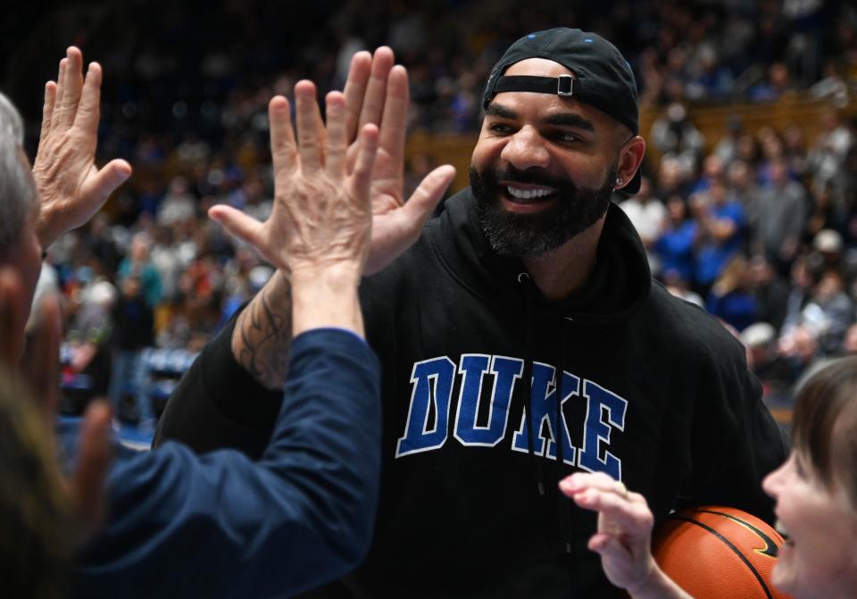 Former Duke All-American Carlos Boozer greets fans during halftime after being inducted into the 2022 class of the Duke Hall of Fame at Cameron Indoor Stadium.