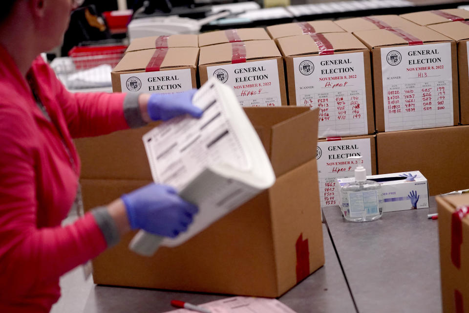 An election worker boxes tabulated ballots inside the Maricopa County Recorders Office, Wednesday, Nov. 9, 2022, in Phoenix. (AP Photo/Matt York)