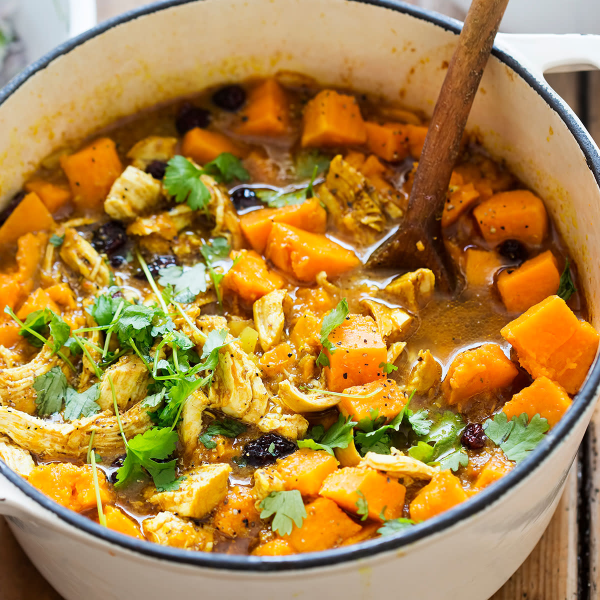 pot of stew with chicken, cumin, turmeric, coriander, and sweet potatoes