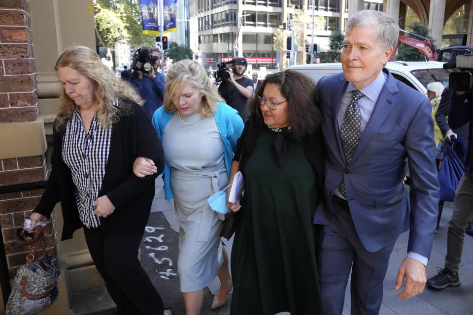 FILE - Steve Johnson, right, with his sisters, Terry, left, and Rebecca and his wife Rosemarie, second right, arrive at the Supreme Court in Sydney on May 2, 2022, for a sentencing hearing in the murder of Scott Johnson, Steve, Terry and Rebecca's brother. An Australian pleaded guilty on Thursday, Feb. 23, 2023, to the manslaughter of an American Scott Johnson, who fell to his death 35 years ago from a Sydney cliff top that was known as a gay meeting place. (AP Photo/Rick Rycroft, File)