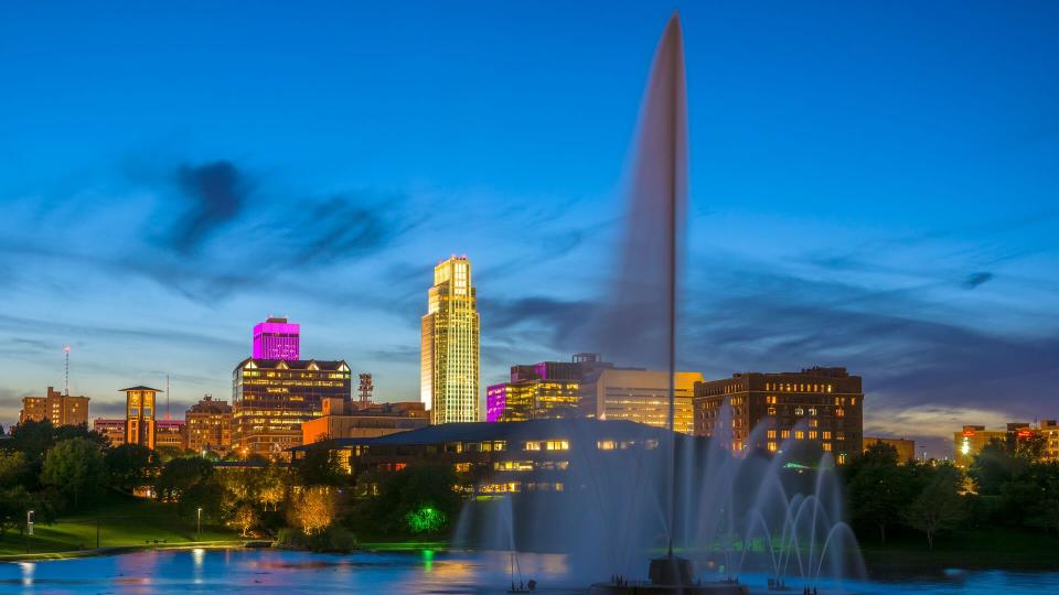 Downtown Omaha skyline with the Heartland of America Park, including a large fountain, in the foreground.