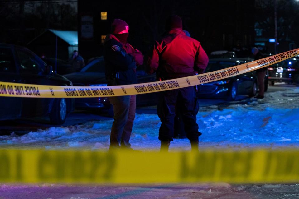 Police gather near a scene where multiple bodies were discovered on McNichols Road and Log Cabin Street in Detroit, Thursday, Feb. 2, 2023.